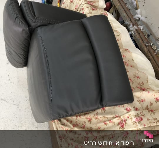 כרית עור שחורה על כיסוי פרחוני